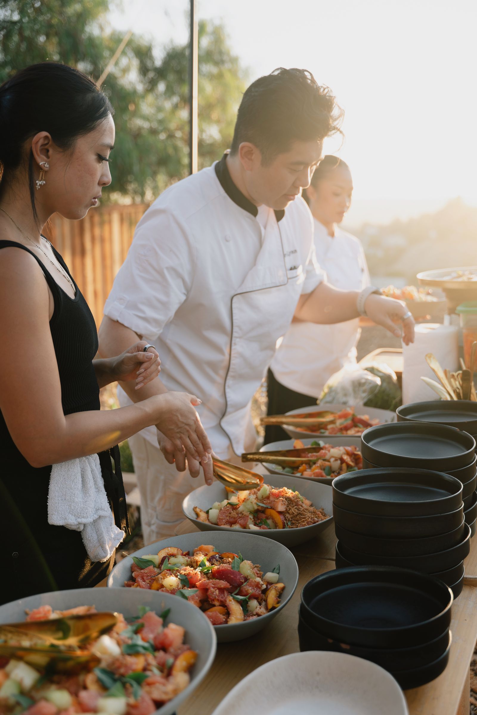 Guests, fire and the long table at the Rosalynn Summer Series dinner on 8 August 2026