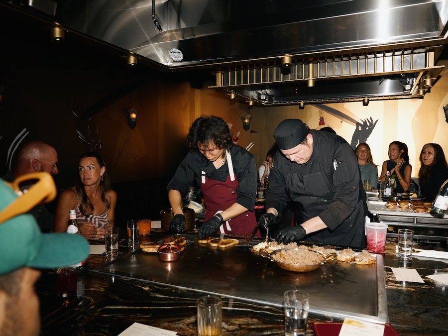Chefs working the teppan counter with guests seated around it at Maison Kasai DTLA