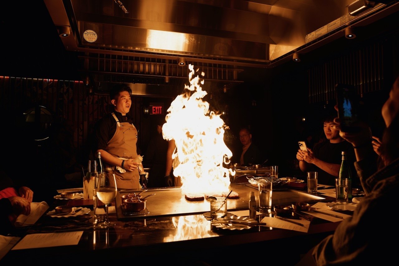 Flames rising from the teppan counter at HOT PLATE: Chef Showdown, Maison Kasai DTLA